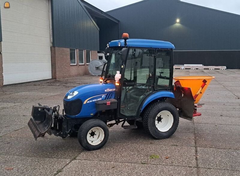 New Holland boomer met zoutstrooier en schuif/veegmachine